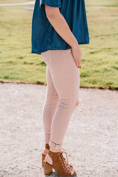 blush pink mid rise skinny jeans with knee slits