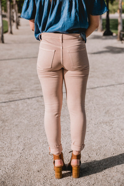 blush pink mid rise skinny jeans with knee slits
